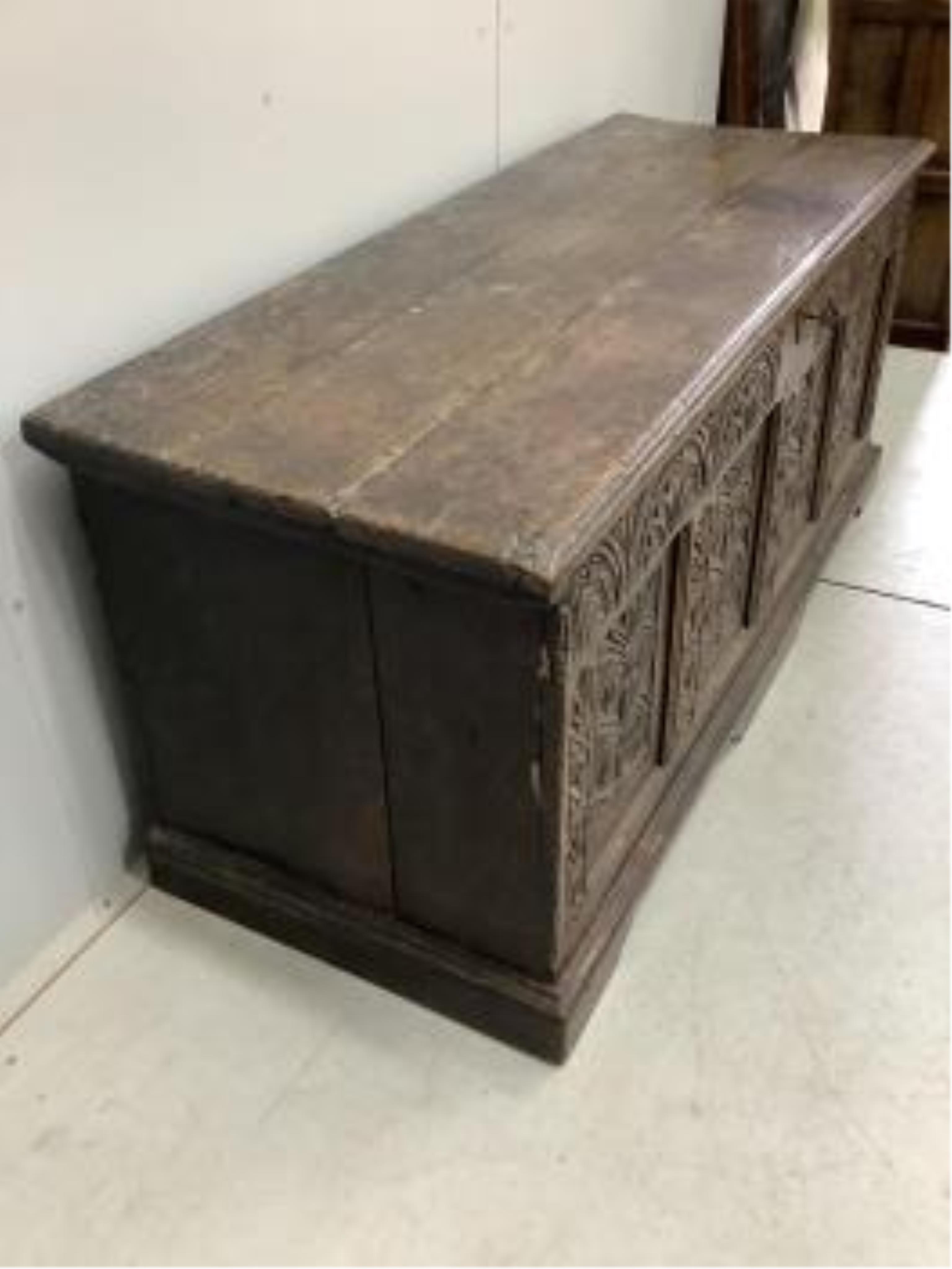 A 17th century and later strapwork carved oak coffer, width 160cm, depth 61cm, height 70cm. Condition - poor to fair